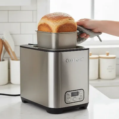 Cuisinart CBK-110 Compact Automatic Bread Maker on a modern kitchen counter, showcasing its vertical design and stainless steel finish.